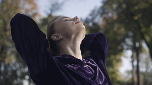 Closeup Face of Confident Sportswoman Making Ponytail