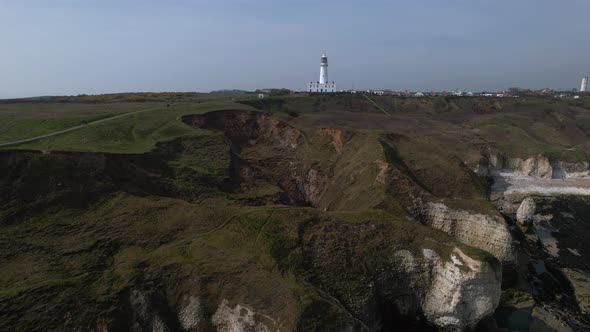 Drone Ascends On White Chalk Cliffs And The Lighthouse At Flamborough, East Riding of Yorkshire. Eng