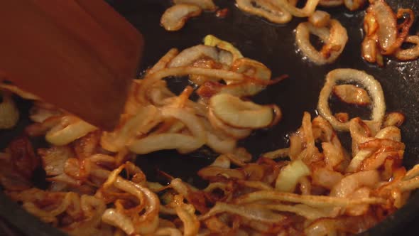 Closeup of Onion Rings Frying and Caramelizing in Sugar on the Pan
