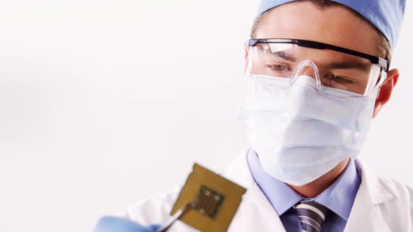 Technician repairing motherboard chip