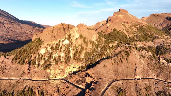 Aerial Panoramic Dramatic View of a Wilderness Mountain Peak and a Road Forest Rocky Volcanic