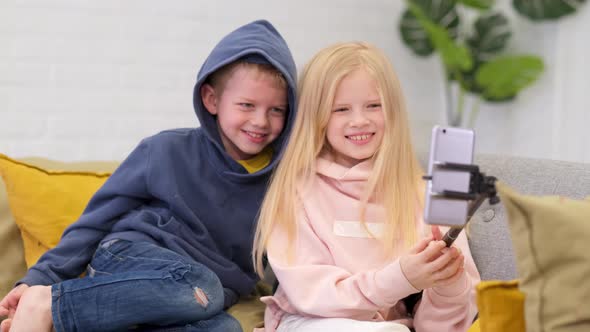 Kids Bloggers Talking with Followers Live Streaming Looking to Smartphone Screen at Home