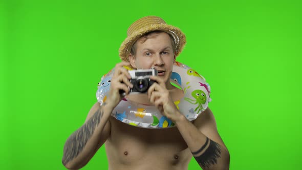 Shirtless Man Tourist Photographer Is Taking Photos on Retro Camera. Chroma Key