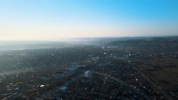 the Drone's Flight Over the City in the Morning at Sunrise