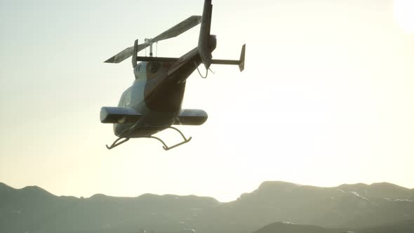 Extreme Slow Motion Flying Helicopter and Sunset Sky