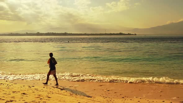 Guy angling on relaxing sea view beach journey by blue ocean with clean sand background of Gili Traw