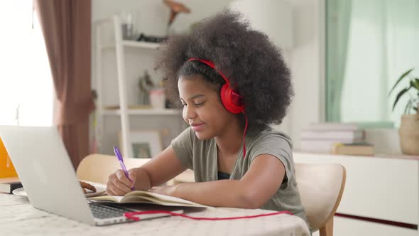 4K Little African girl online study on laptop computer with teacher