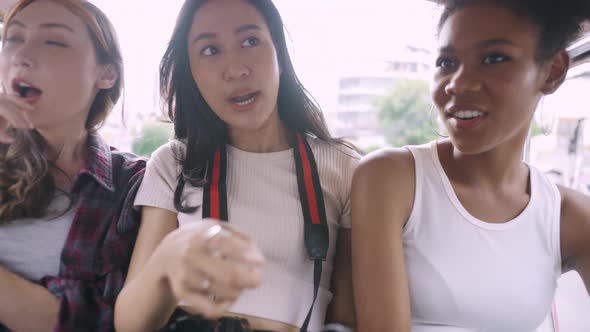 A group of multi-ethnic female friends enjoying the city tour.