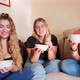 Three young women smiling to camera and eating fruit salad from bowls, Italy - VideoHive Item for Sale