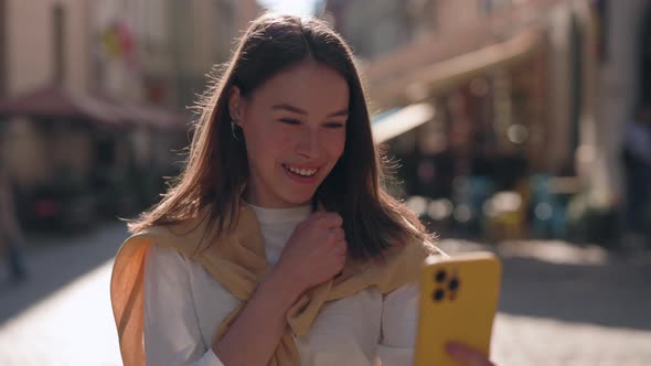 Smiling Woman with Hearing Loss Using Mobile for Video Call