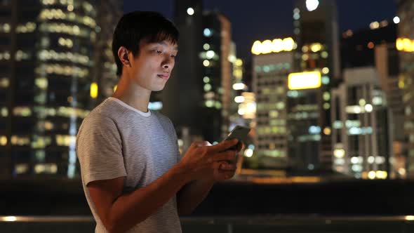 Man using mobile phone in evening 