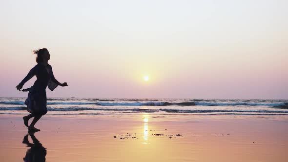 Silhouette of Young Woman Performing Grand Jete Jump on the Beach in Slow Motion