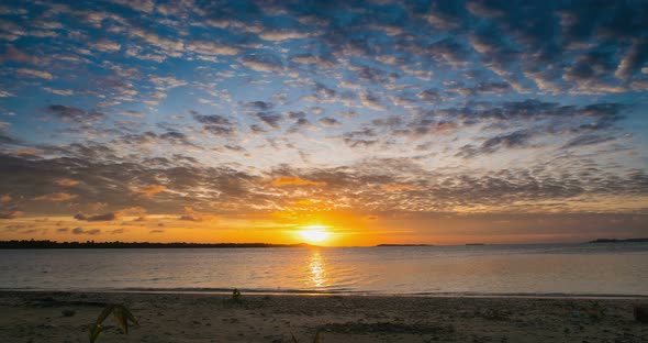 Time lapse: sunrise over tropical beach and sea colorful dramatic sky