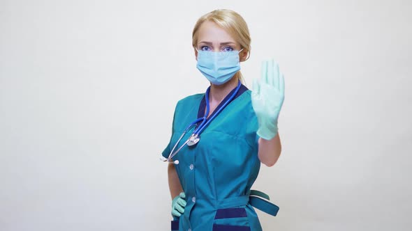 Medical Doctor Nurse Woman Wearing Protective Mask and Rubber or Latex Gloves - Stop Sign Gesture