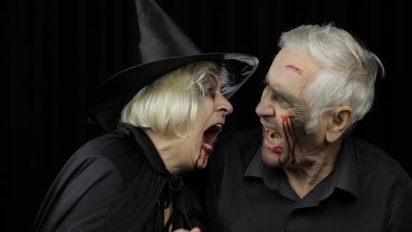 Elderly Man and Woman in Halloween Costumes. Dripping Blood on Their Faces