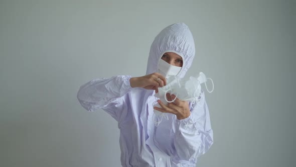 Lucky Joyful Medical Worker Fully Dressed in Protective Suit Flexing Having Fun with Face Protective