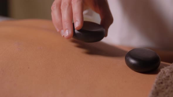 Beautiful Woman Having Hot Stone Massage at Spa