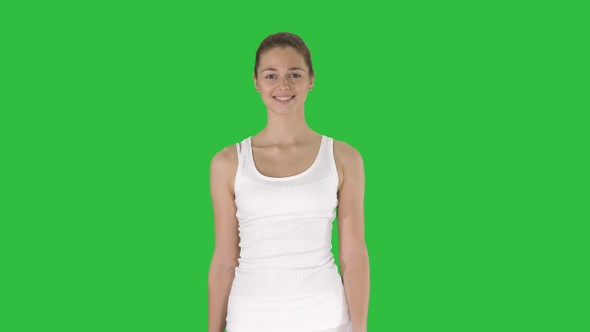 Young woman walking on a Green Screen, Chroma Key