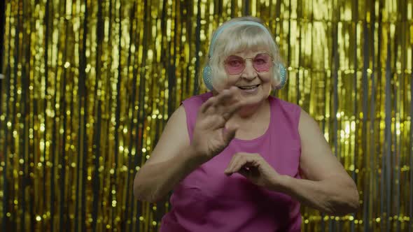 Friendly Senior Old Woman Waving Hands Looking at Camera with Toothy Smile, Saying Hi, Greeting