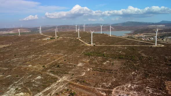 Aerial View Over the Farm Landscape and Wind Turbines Generating Clean Renewable Energy