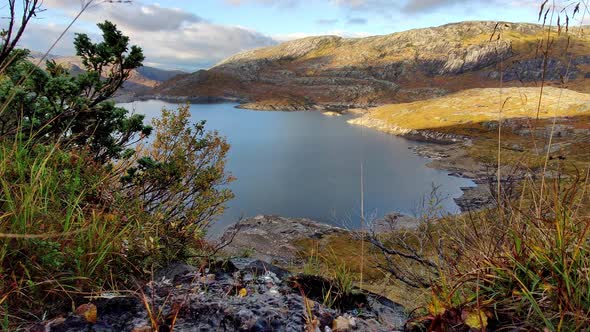 Stream flowing gently into man made dam  - Stream close to camera with Grondalsvatnet water reservoi