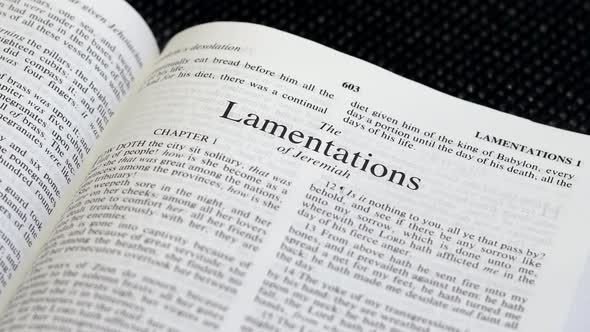 Close Up Shot of  Bible Page Turning to the book of Lamentations