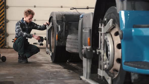 Technical Engineer Changing Tire of a Bus or Truck