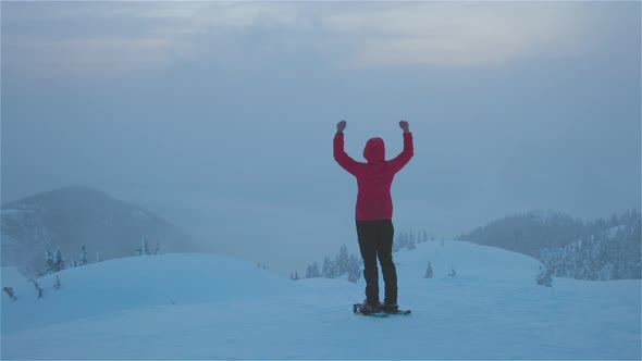 Adventure Girl With Snowshoes Hiking on Top of the Mountain