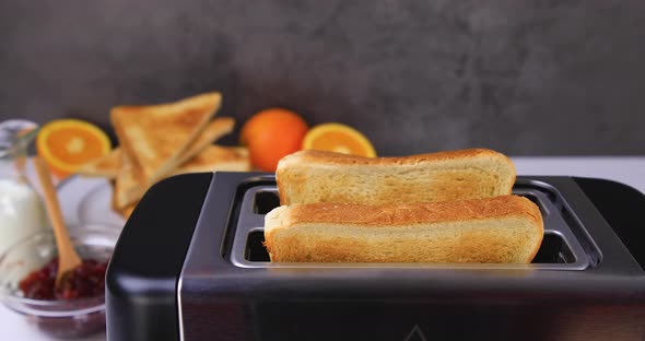 Slices of Toast Coming Out of the Toaster 