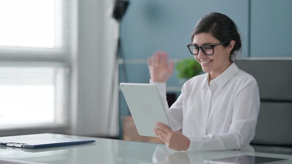 Indian Businesswoman making Video Call on Tablet in Office