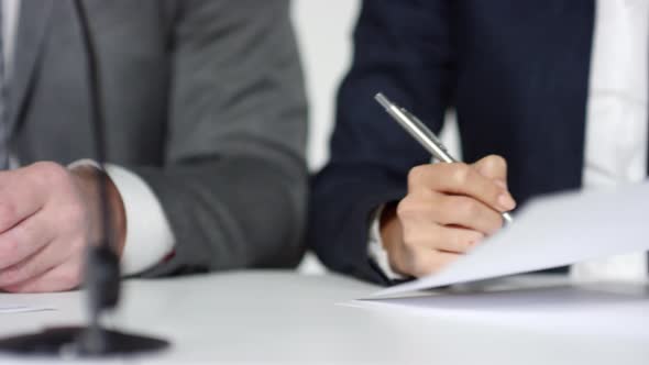 Unrecognizable Business Partners Signing Document