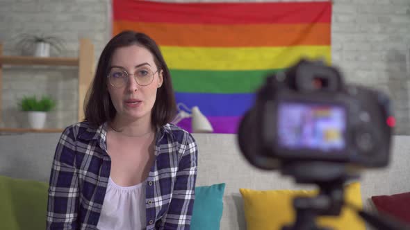 Young Pretty Woman Blogger in the Shirt on the Background of the Flag of the LGBT Records Video