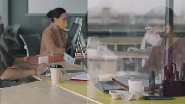 People in Face Masks Working in Office during Pandemic