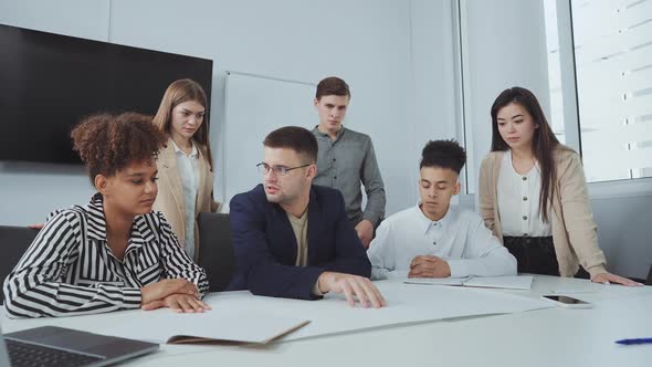 Team of Designers Discussing Plan at Meeting