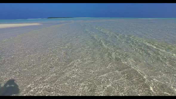 Aerial travel of relaxing resort beach trip by shallow water and bright sandy background of a dayout