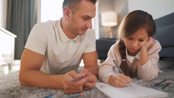 Father and Daughter Communicate, Having Fun and Painting Together. Concept of a Happy Family and