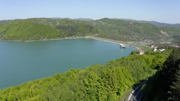 Maneciu Reservoir Surrounded By Mountain Foliage With Asphalt Road In Prahova County, Muntenia, Roma