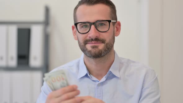 Portrait of Middle Aged Man Counting Dollars