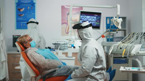 Patient Talking with Doctor Dressed in Protective Suit