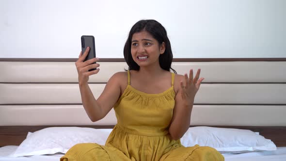 Angry Indian woman talking on a video call