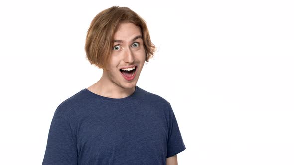 Portrait of Surprised Man in Casual Tshirt Laughing with Perfect Teeth and Bulging Eyes in