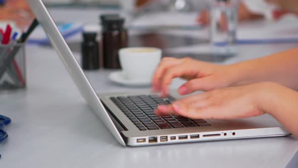 Close Up of Assistant Using Laptop Writing Meeting Informations