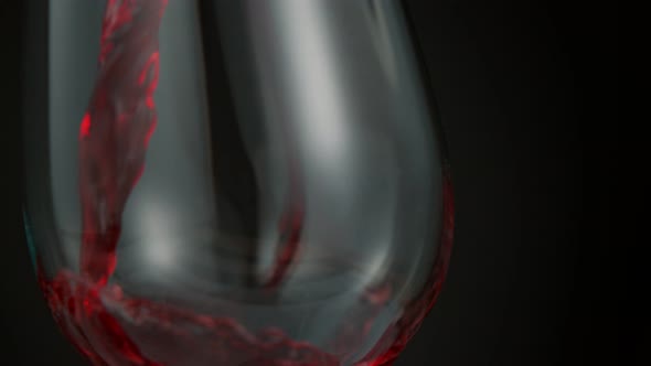 Pouring Red Wine in Super Slow Motion on Black Background