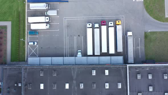 Aerial view of the logistics warehouse with trucks waiting for loading