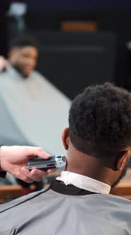 Young Africanamerican Man Visiting Barbershop for Haircut
