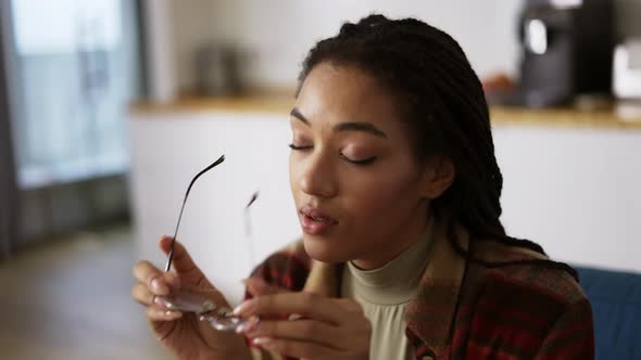 Exhausted African American Woman Putting Off Eyeglasses and Lay Down on Sofa