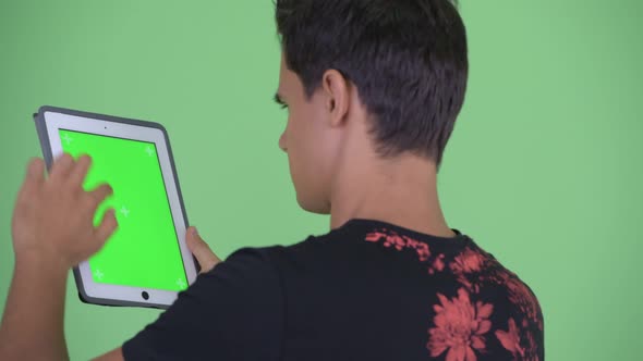 Closeup Rear View of Young Man Using Digital Tablet