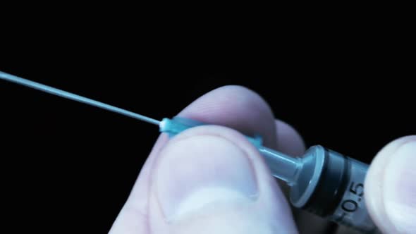 Put A Needle On The Syringe On Black Background 3