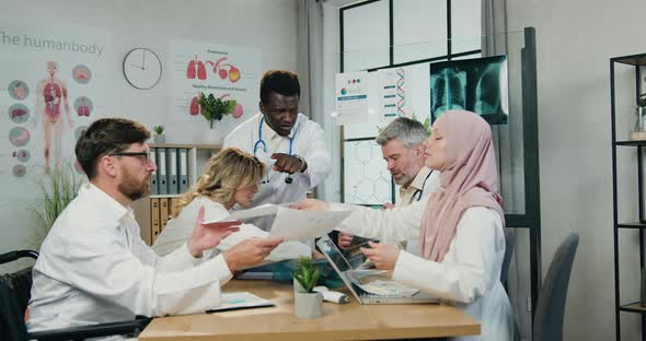 Multiethnic Male and Female Medical Workmates Get Aquainted with Different Reports