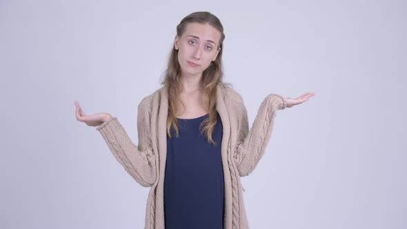 Young Confused Pregnant Woman Shrugging Shoulders
